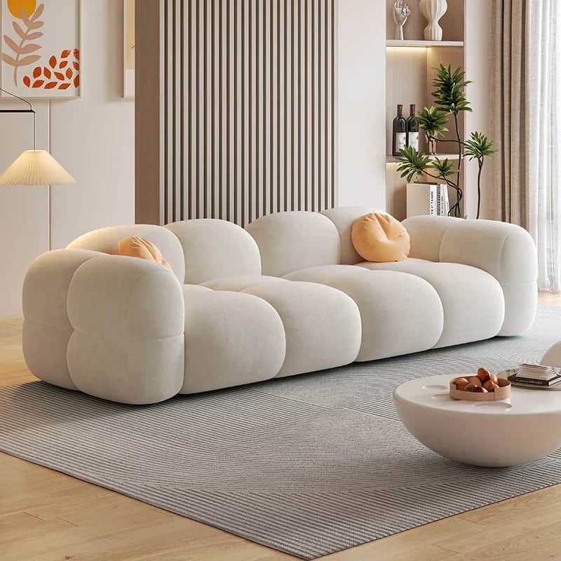 A long, contemporary sofa composed of multiple rounded, cloud-like upholstered sections, presented i… — 3D model