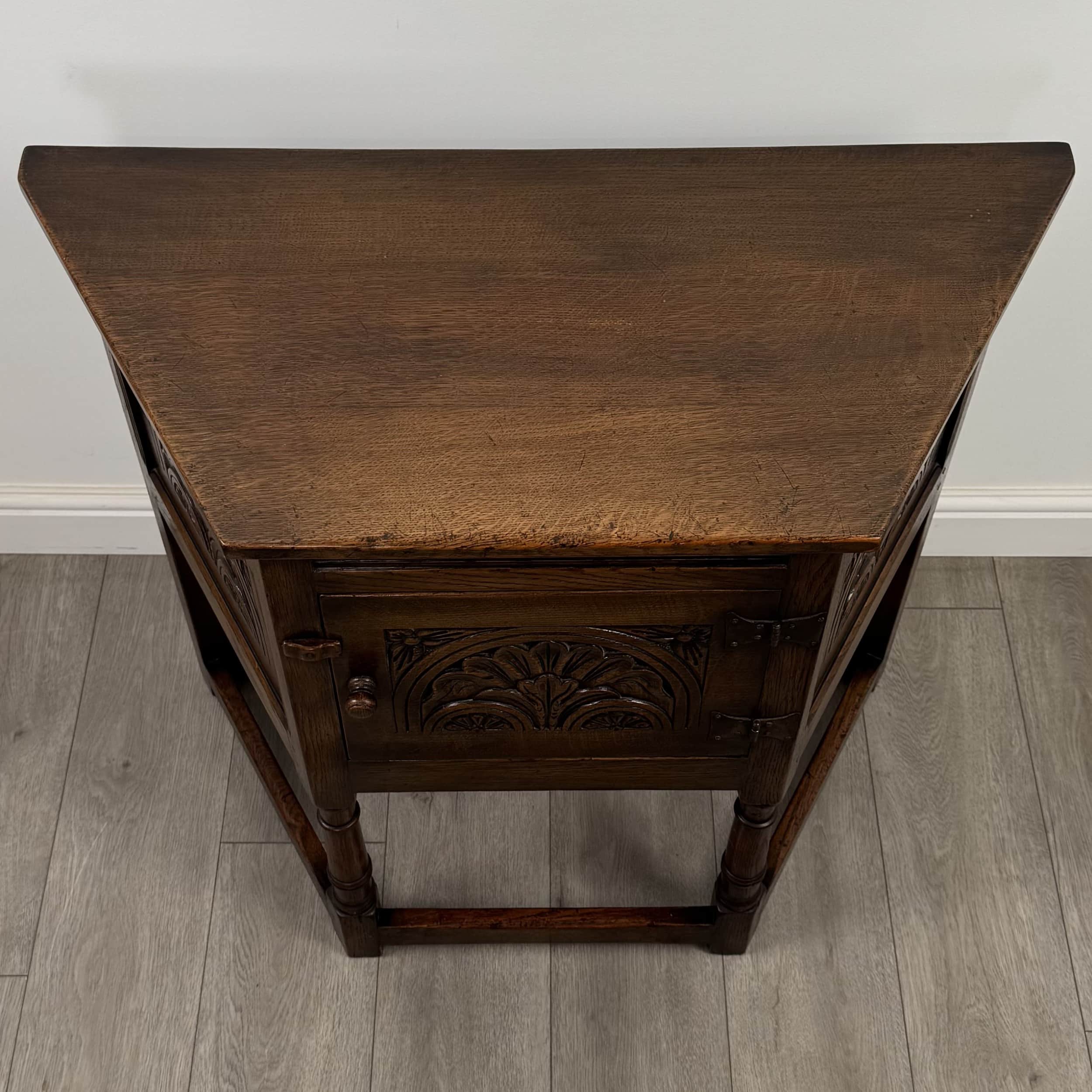 A vintage wooden cabinet with a triangular top. The front features carved decorative elements, a hin… — free OBJ 3D model