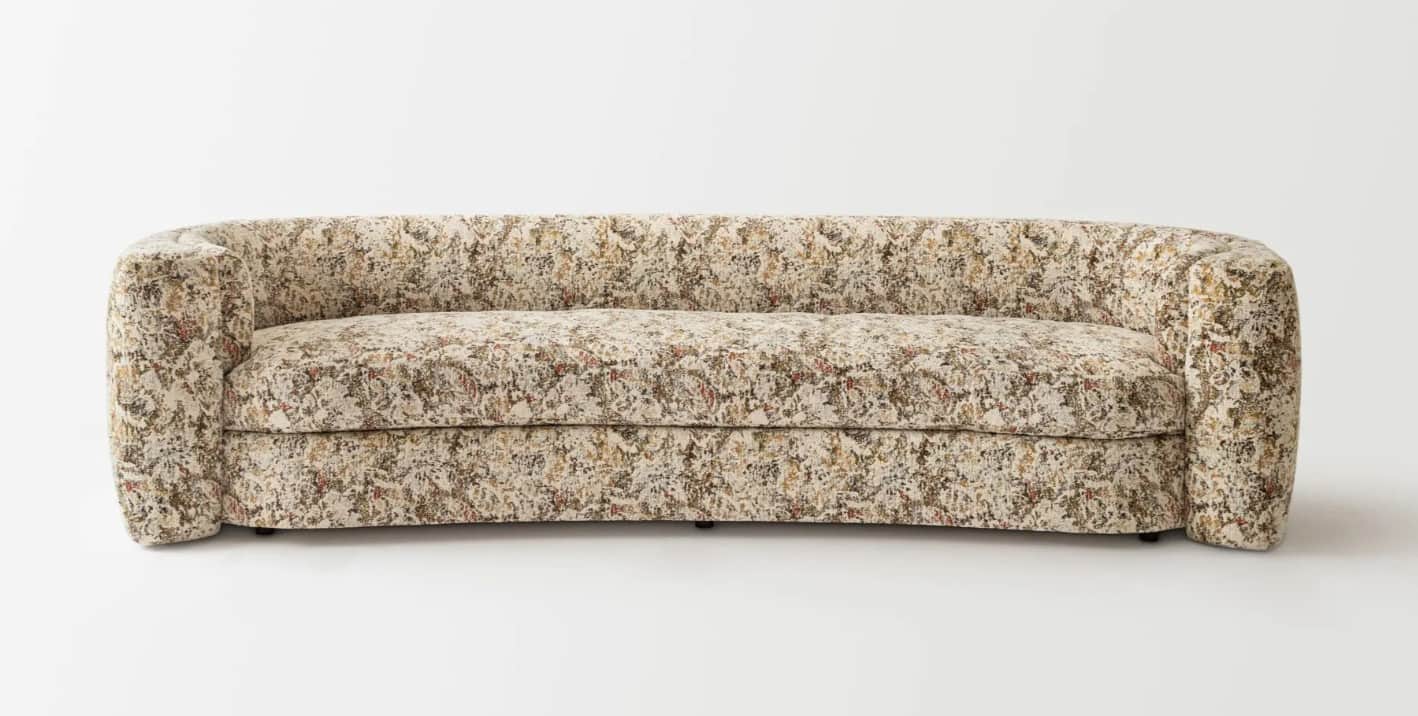 A curved sofa upholstered in a textured fabric with an abstract pattern. The sofa features rounded a… — free FBX 3D model