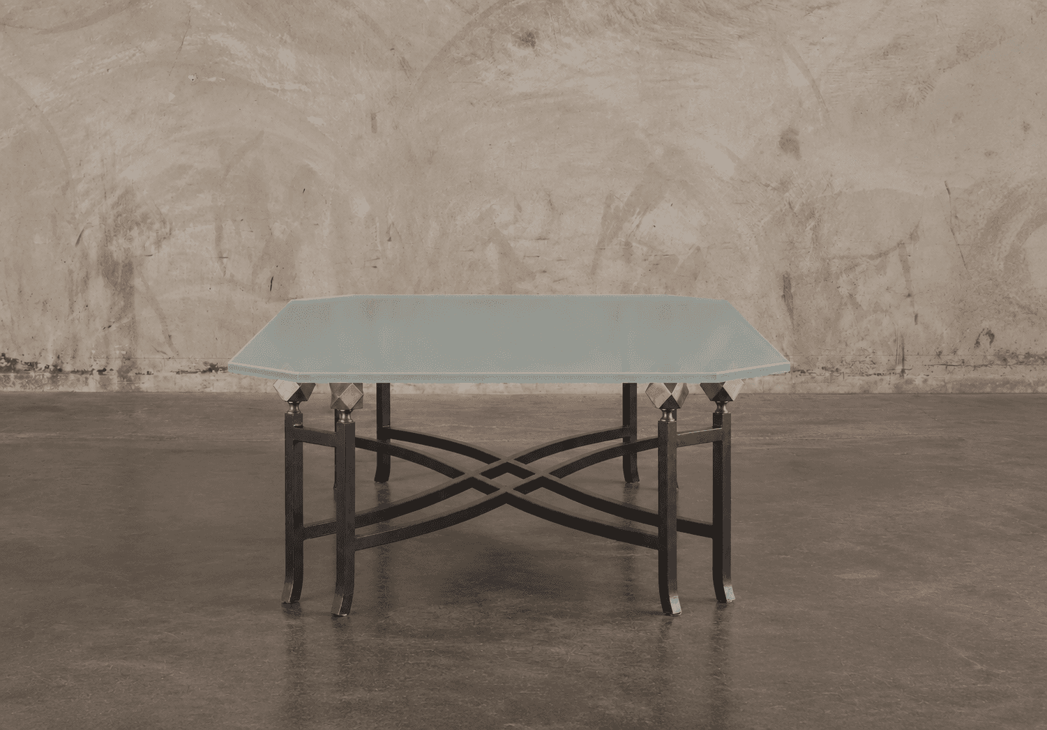 A low-profile table featuring a frosted glass top with an octagonal shape, supported by a wrought ir… — 3D model