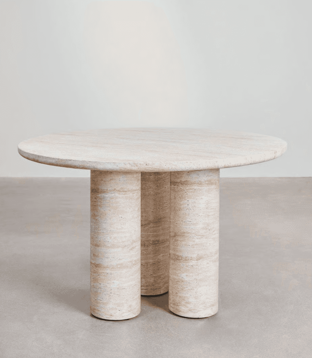 A round dining table with a marble or travertine top and three cylindrical legs. The material exhibi… — 3D model