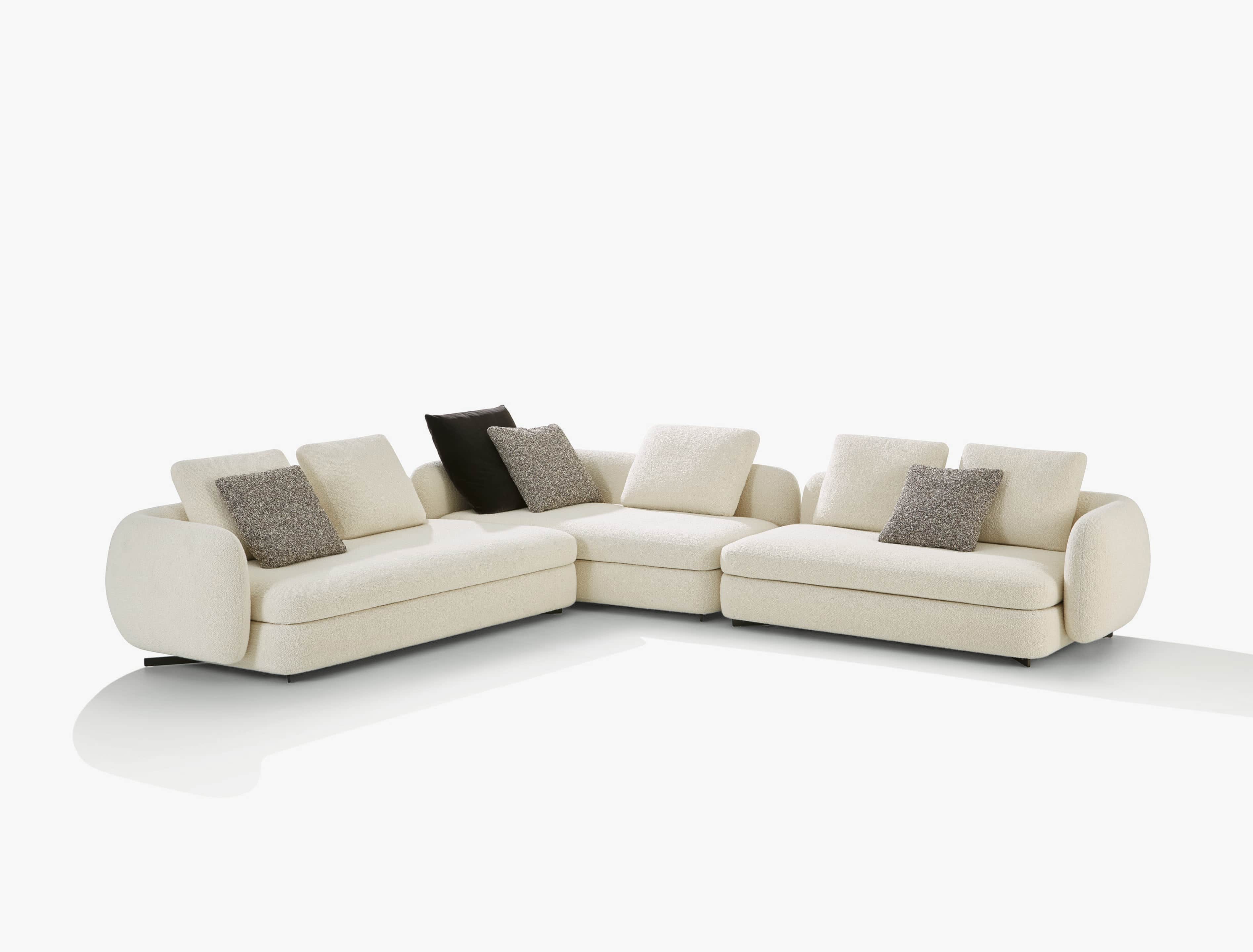 A contemporary L-shaped sectional sofa upholstered in a light cream-colored boucle fabric, featuring… — 3D model