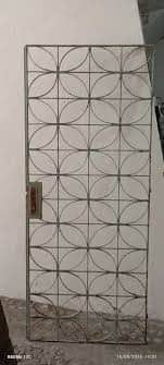 A tall, narrow, rectangular metal screen panel featuring a repeating geometric pattern of interconne… — 3D model
