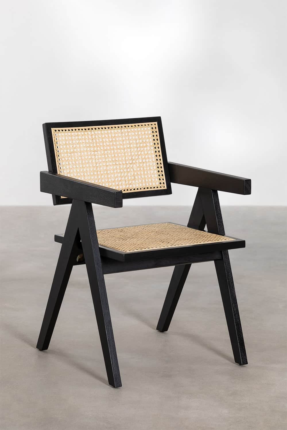 A modern armchair with a black wooden frame and woven cane seat and backrest. The chair features a d… — free OBJ 3D model