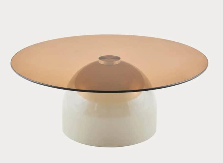 A coffee table with a round, amber-tinted glass top and a white, bulbous base. The base has a glossy… — 3D model