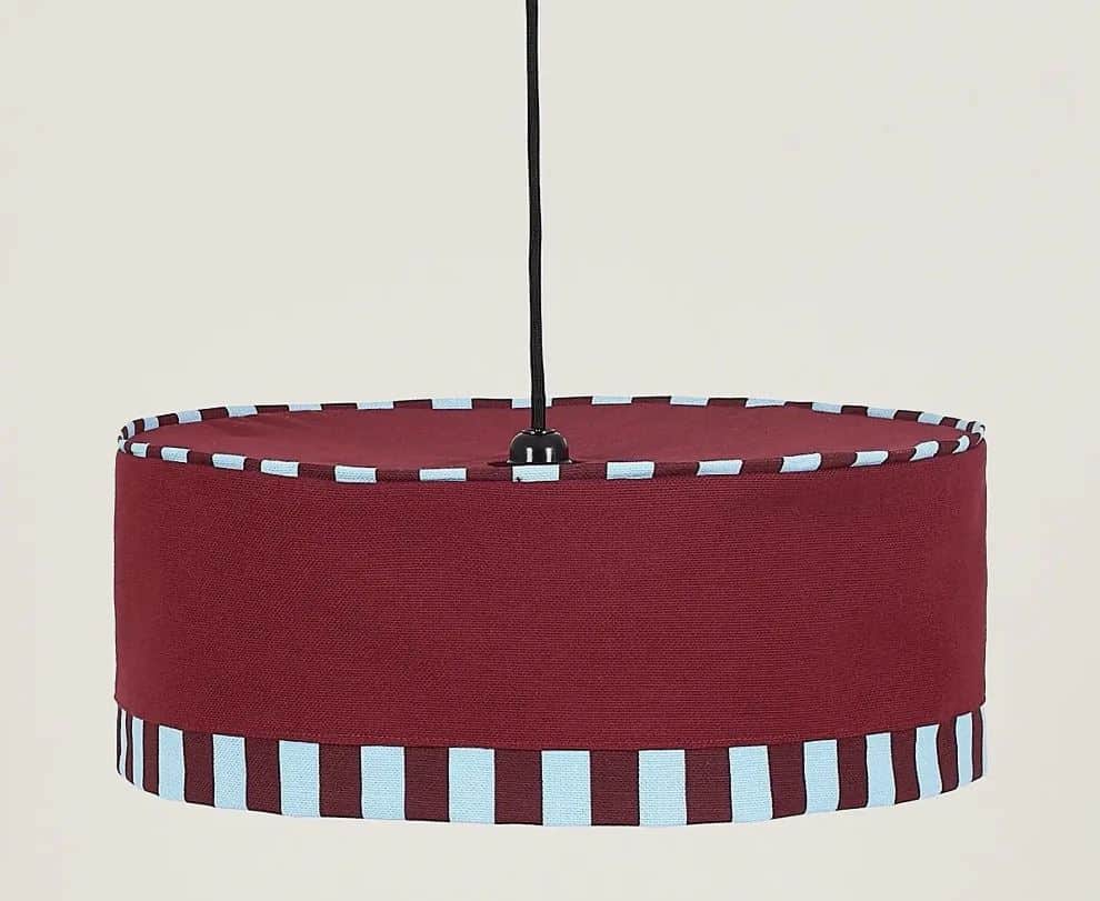 A contemporary drum-shaped pendant light featuring a main body crafted from burgundy-colored fabric.… — 3D model