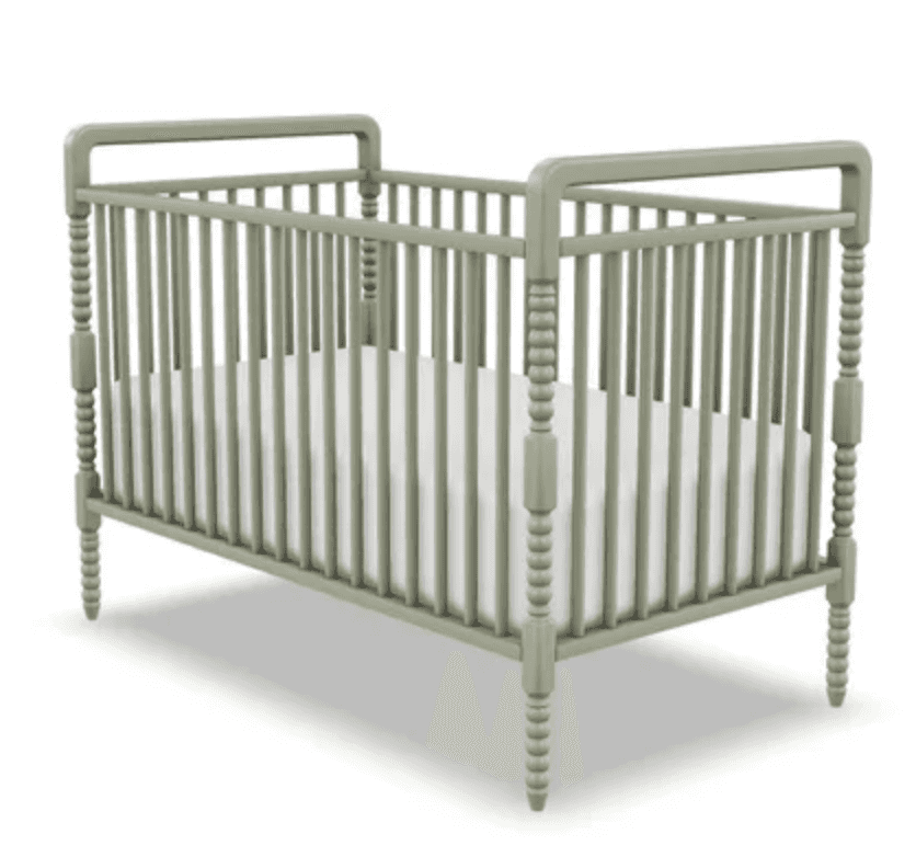 A traditional baby crib featuring vertical spindles and decorative turned posts, finished in a muted… — 3D model