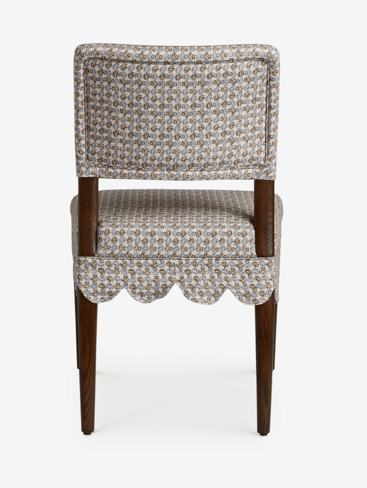 A traditional upholstered side chair featuring a scalloped fabric skirt and a small floral pattern.… — 3D model