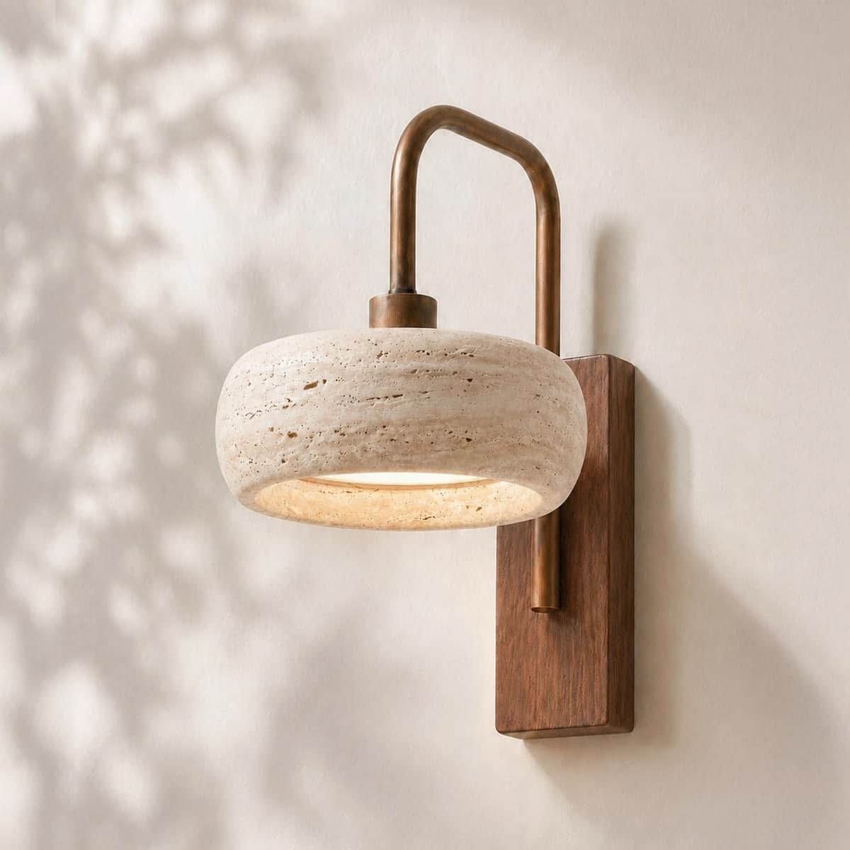 A modern wall sconce featuring a bowl-shaped shade crafted from rough-textured travertine stone. The… — 3D model