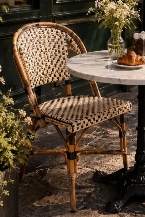 A classic French bistro-style dining chair, featuring a natural bamboo or rattan frame with a curved… — 3D model