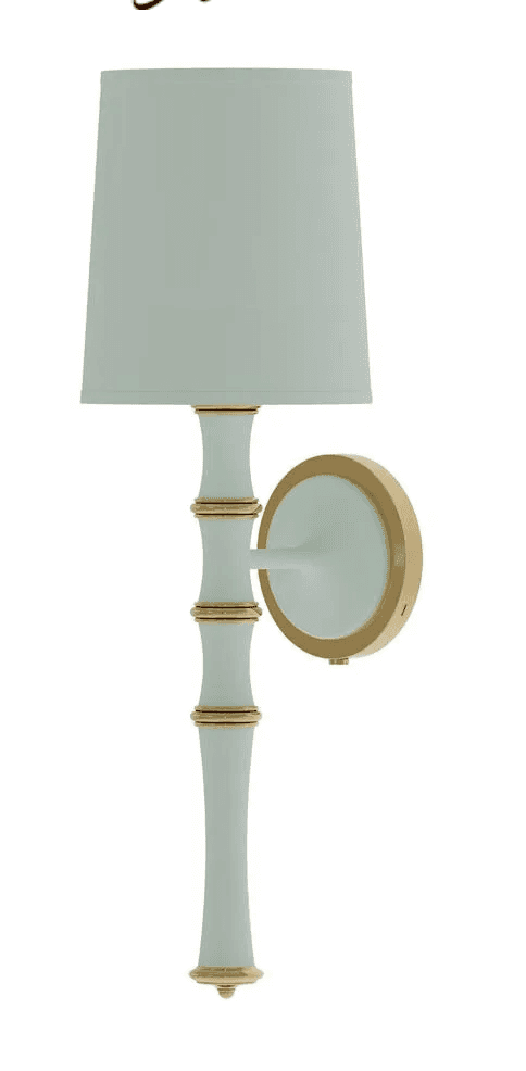 A decorative wall sconce featuring a tapered fabric shade and a bamboo-inspired stem, finished in a… — 3D model