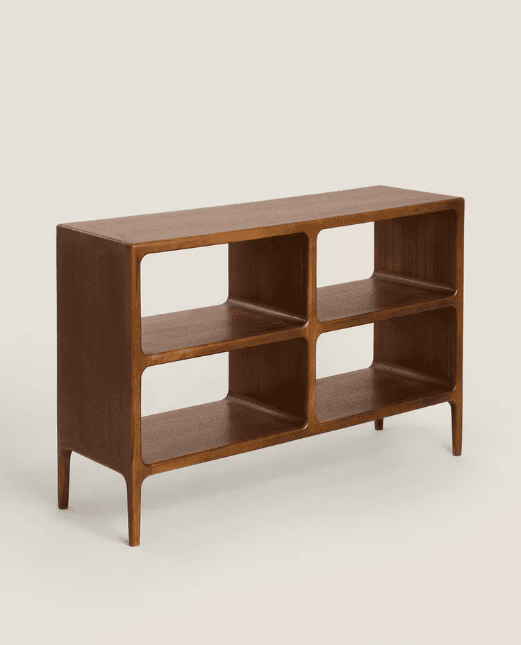 A low, rectangular bookshelf with an open design. It features a smooth, finished wooden surface and… — 3D model