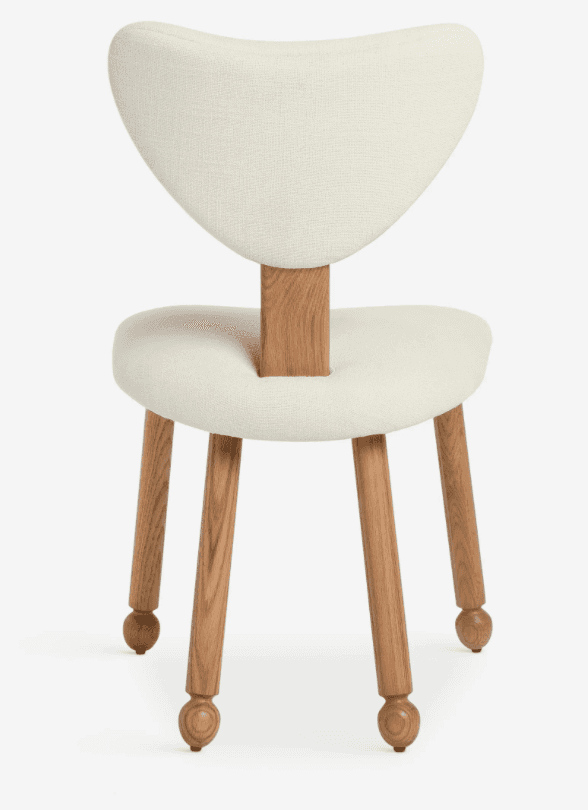 An armless dining chair featuring an off-white upholstered seat and a distinctive sculpted backrest.… — 3D model