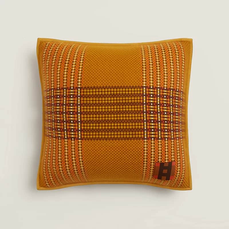 A square decorative cushion featuring a prominent plaid pattern in shades of mustard yellow, burnt o… — 3D model