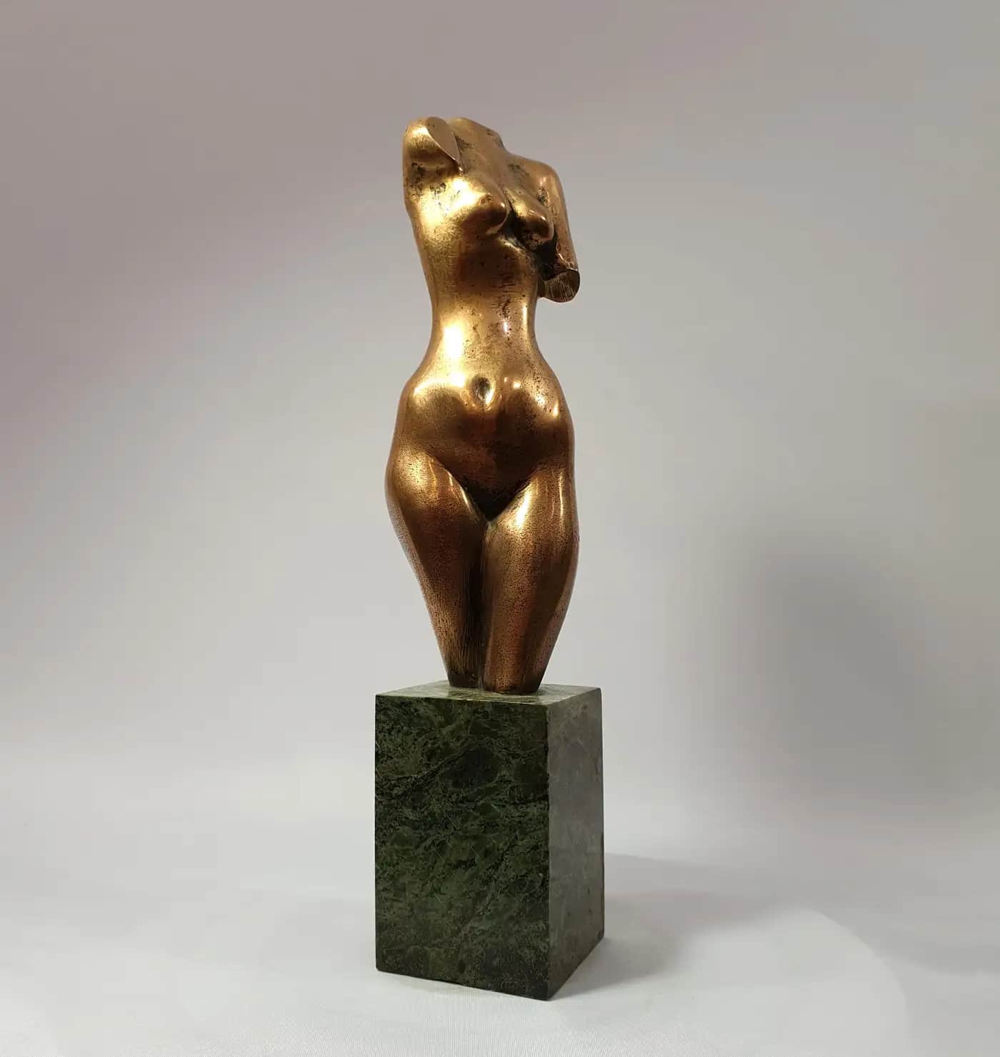 A bronze-finished sculpture depicting the headless and armless torso of a female figure, mounted on… — free FBX 3D model