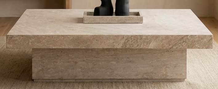 A rectangular, low-profile table constructed from light-colored travertine stone, featuring a thick,… — 3D model
