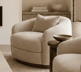 An upholstered barrel-shaped chair with a rounded back, integrated arms, and a loose back cushion, f… — 3D model