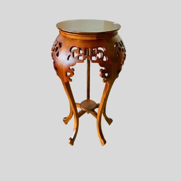 A round, carved wooden pedestal table featuring ornate East Asian-inspired openwork carvings on its… — 3D model