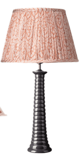A table lamp featuring a pleated fabric lampshade with a paisley-like pattern in peach and white, at… — 3D model