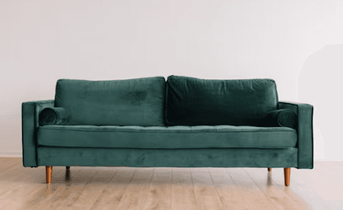 A modern two-seater sofa upholstered in luxurious emerald green velvet fabric, featuring button-tuft… — free BLEND 3D model
