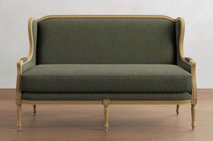 A two-seater sofa with a high, curved back and sloping arms. The frame is exposed wood, featuring a… — 3D model