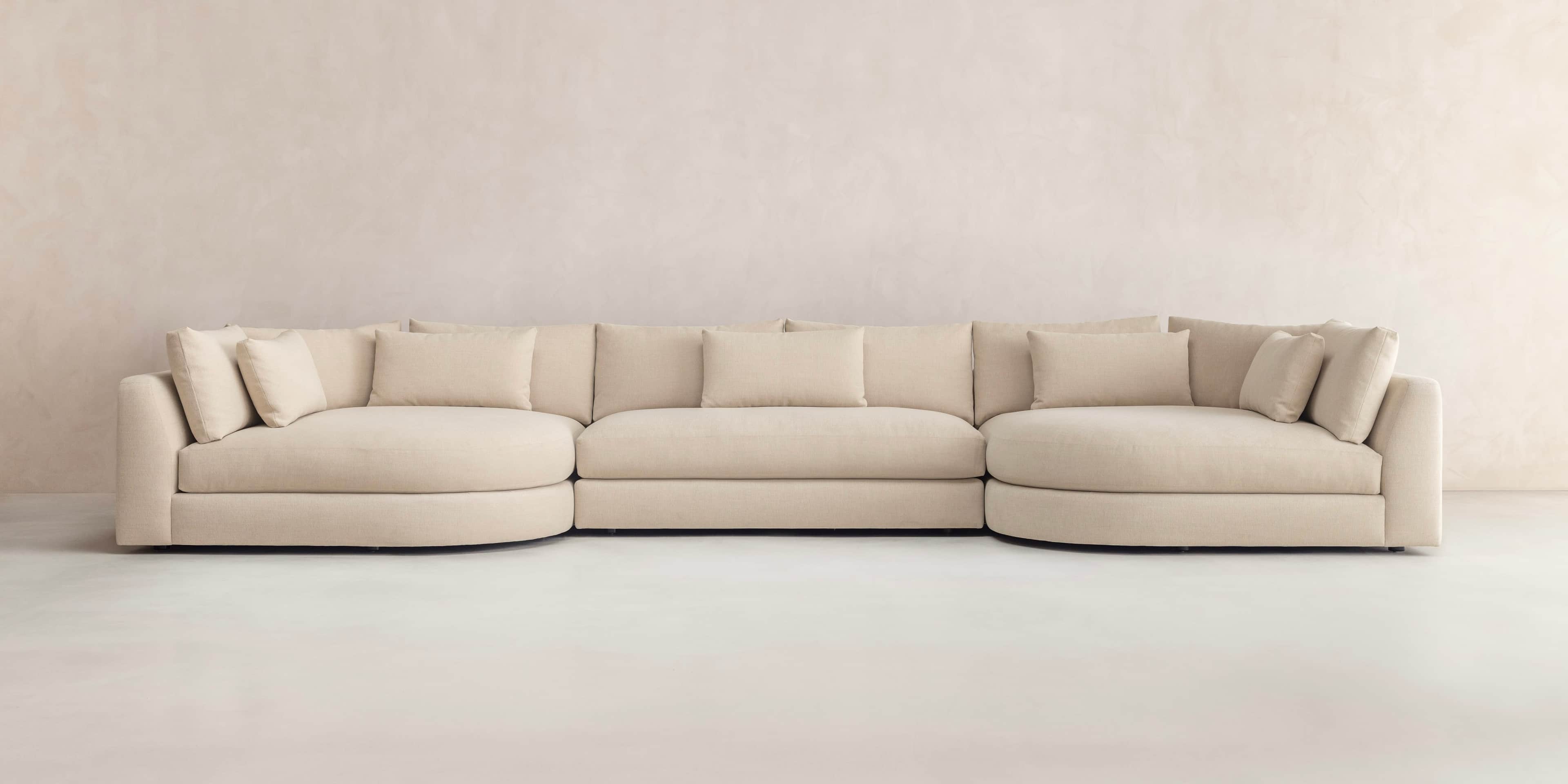 A large, U-shaped modular sectional sofa upholstered in light beige fabric, featuring various straig… — 3D model