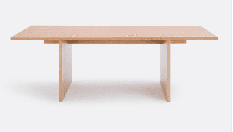 A light-toned wooden rectangular table featuring a thick tabletop and two robust slab-style legs, cr… — 3D model