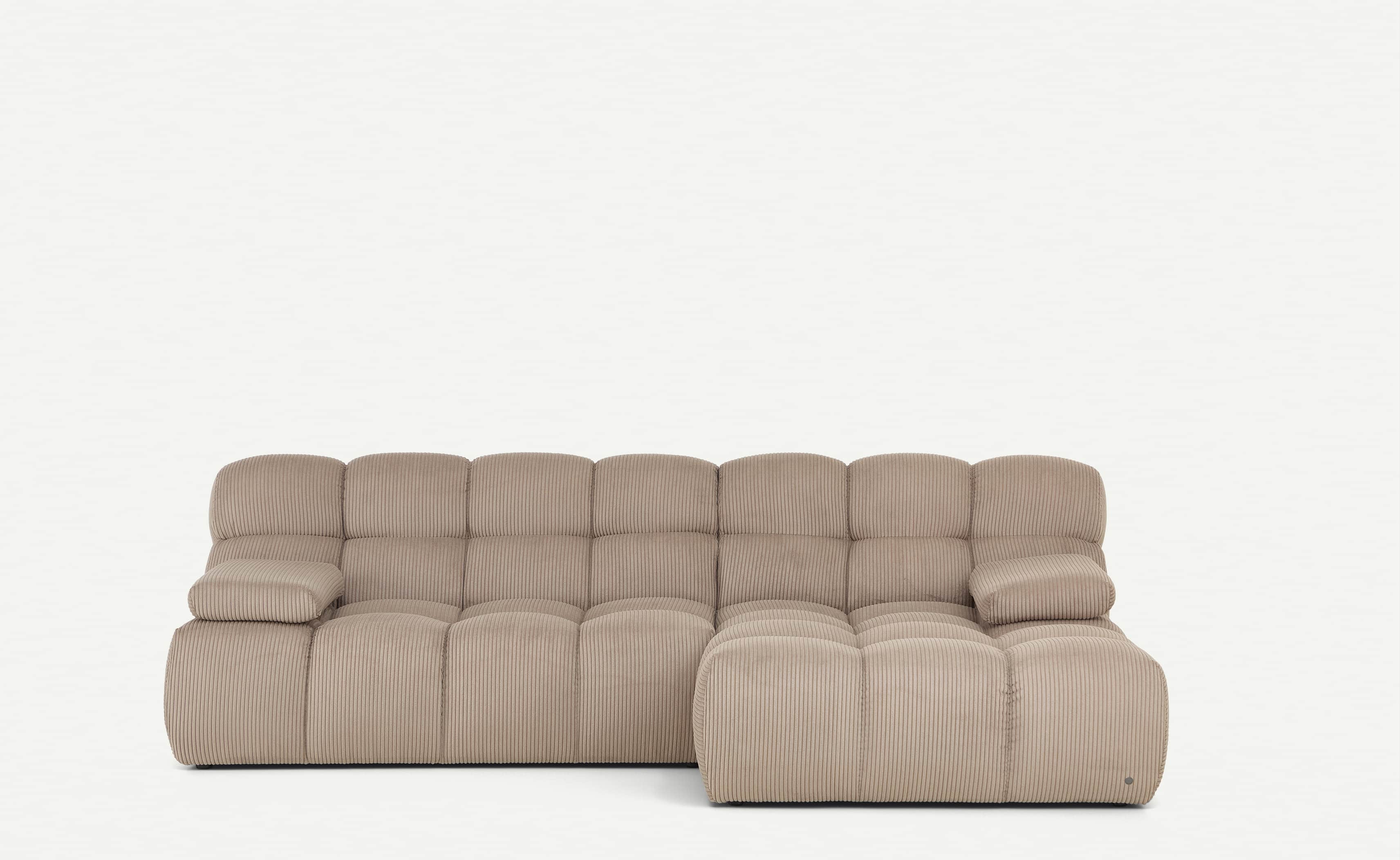A light beige, modular sectional sofa featuring a chaise lounge component on the right side. The ent… — 3D model