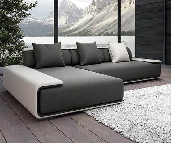 An L-shaped modern sectional sofa featuring dark gray fabric upholstery and a contrasting light-colo… — 3D model