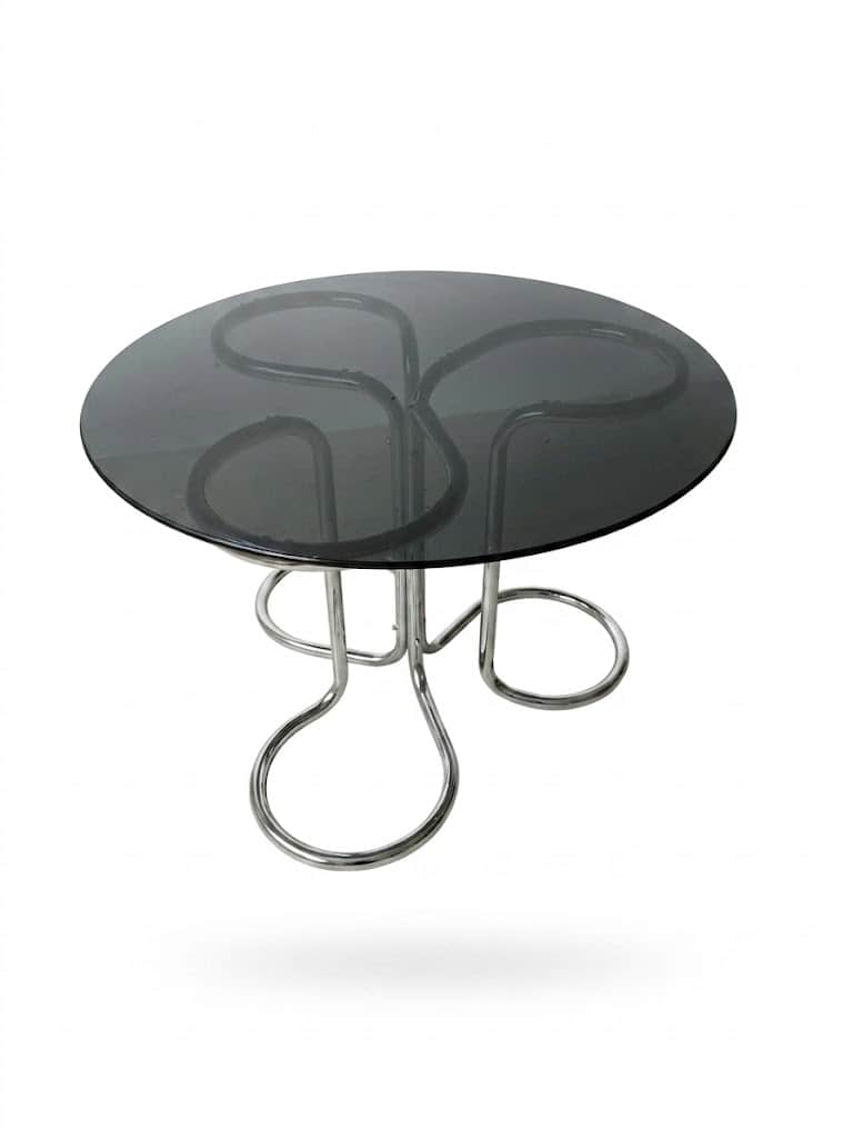 A circular coffee table with a smoked glass top and a chrome-plated metal base. The base features an… — 3D model