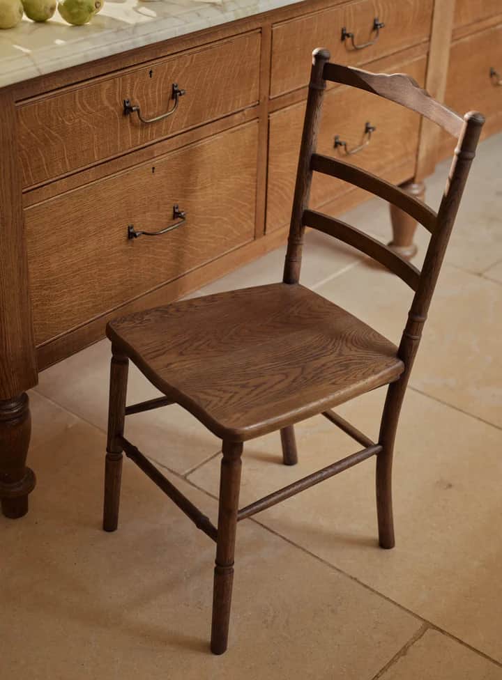A wooden side chair with a square seat, turned legs, and a ladder-back design. The backrest features… — 3D model