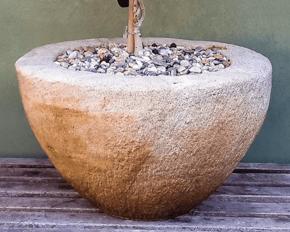 A large, bowl-shaped planter crafted from natural stone, featuring a textured, light brown surface.… — 3D model