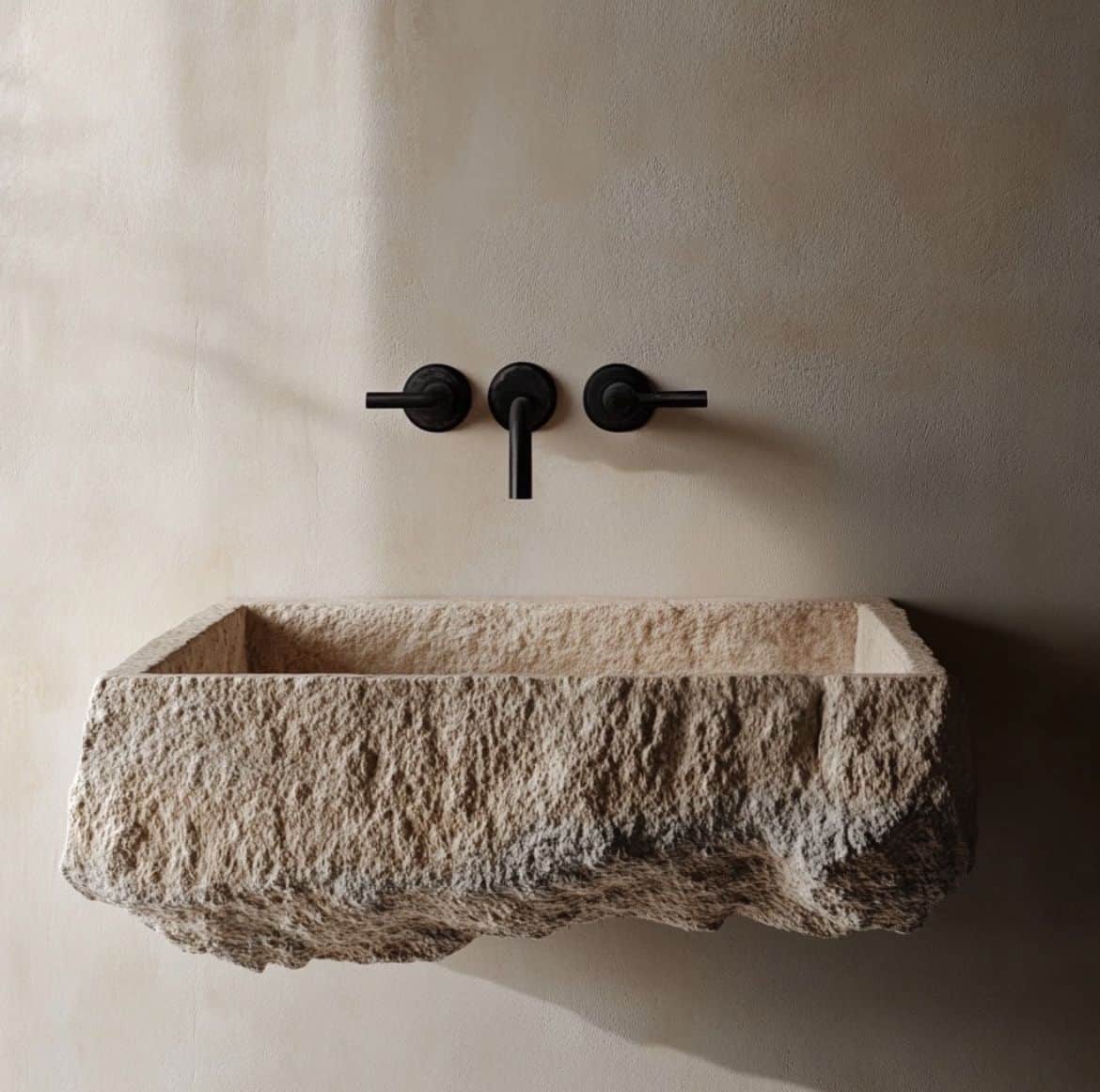 A rectangular stone vessel sink with a rough, natural exterior and a smooth interior. It features a… — 3D model