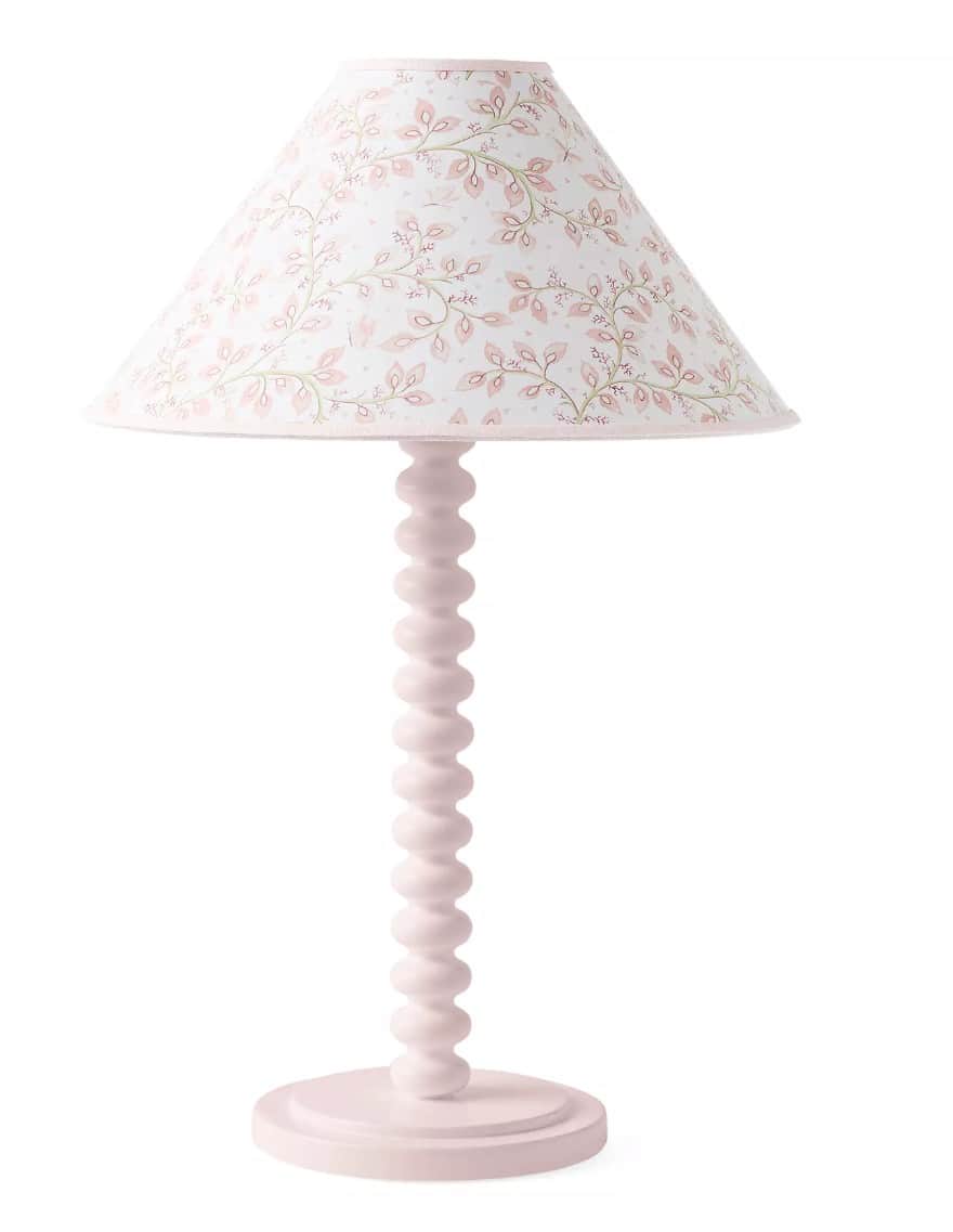 A charming table lamp featuring a solid pink bobbin-turned stem and a circular base. It is topped wi… — 3D model