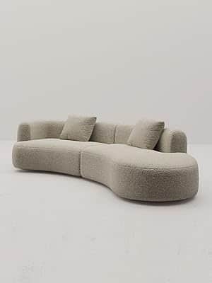 A large, modular, curved sofa with a textured, boucle-like upholstery. The sofa features rounded edg… — free FBX 3D model