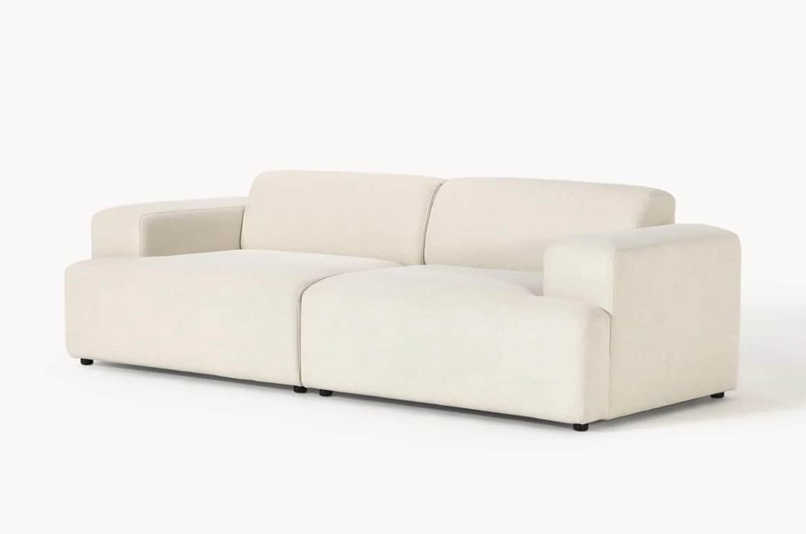A contemporary modular two-seater sofa upholstered in a cream-colored, textured fabric, featuring in… — 3D model