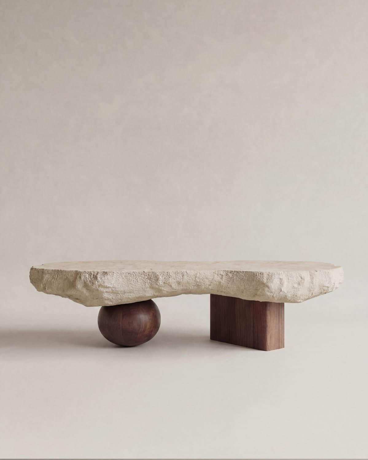 A low-lying coffee table with a large, irregularly shaped stone slab as the tabletop. The tabletop i… — 3D model