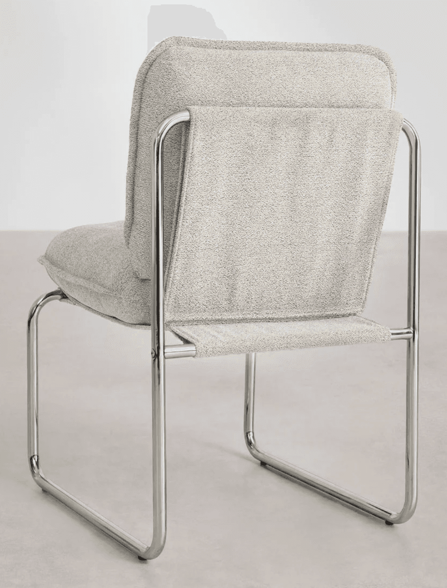 A modern armchair with a tubular metal frame and upholstered seat and back. The frame is constructed… — 3D model