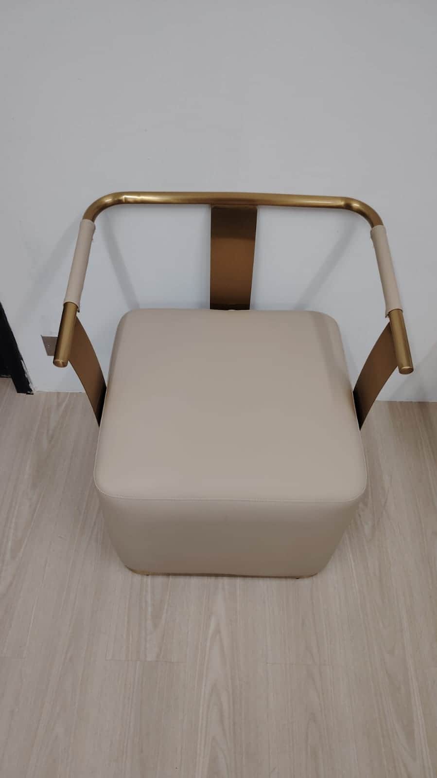A modern armchair featuring a square, thick cushioned seat upholstered in a light beige material, su… — 3D model