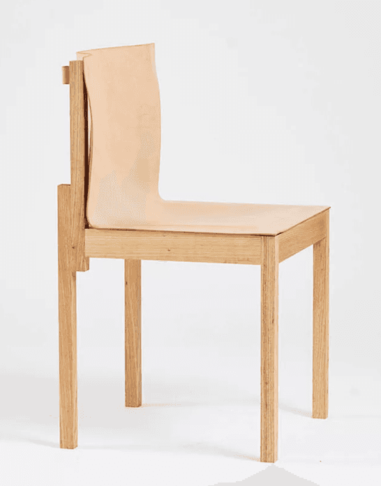 An armless chair featuring a light-toned oak wood frame and a single piece of natural saddle leather… — free GLTF 3D model