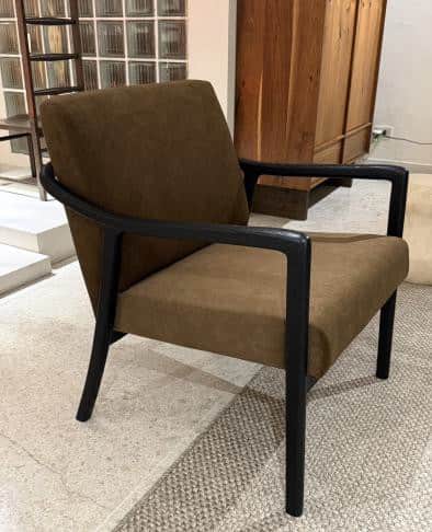 A contemporary armchair with a upholstered seat, backrest, and armrests. The frame and legs are cons… — 3D model