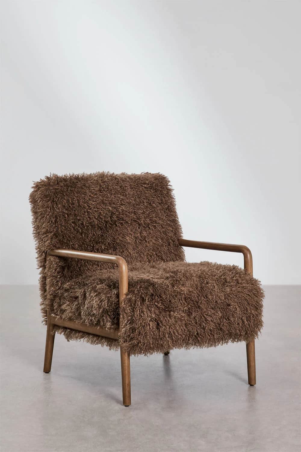 A compact armchair with a wooden frame and a plush, shaggy brown upholstery covering the seat, back,… — 3D model