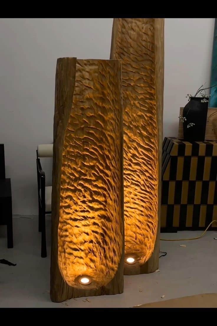 A tall, cylindrical floor lamp crafted from a solid piece of wood, featuring a deeply carved interio… — 3D model