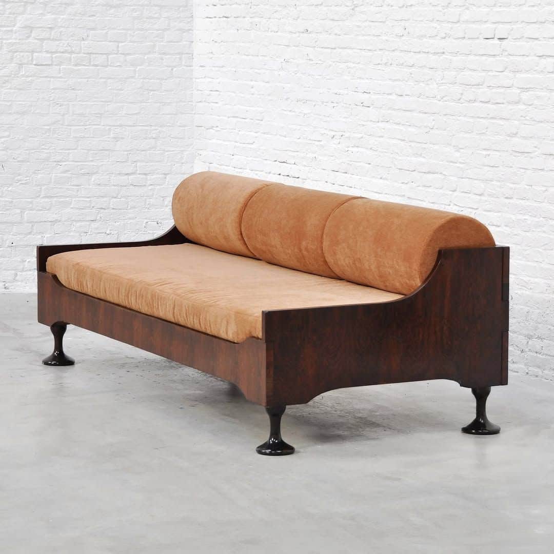 An image showing a modern daybed with a dark wood frame and light orange fabric upholstery. It featu… — 3D model