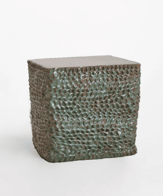 A cube-shaped accent table featuring a heavily textured surface with a dark green, mottled glaze, an… — 3D model