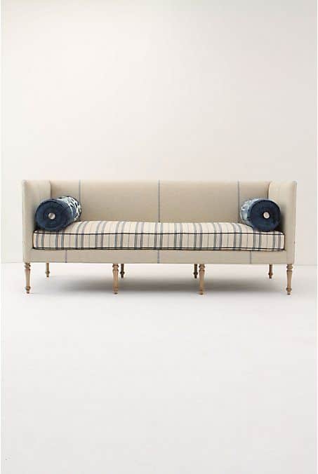 An upholstered daybed settee featuring a beige fabric with a subtle plaid pattern on the exterior fr… — 3D model