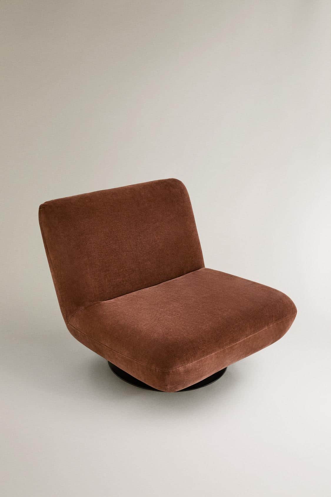 A single-seat armchair with a low profile and a swivel base. The chair features a upholstered seat a… — 3D model
