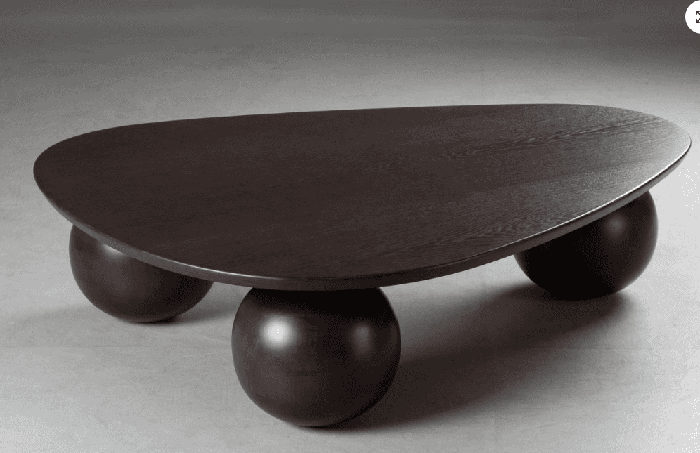 A modern coffee table featuring an irregularly shaped, organic tabletop supported by three robust, s… — free BLEND 3D model