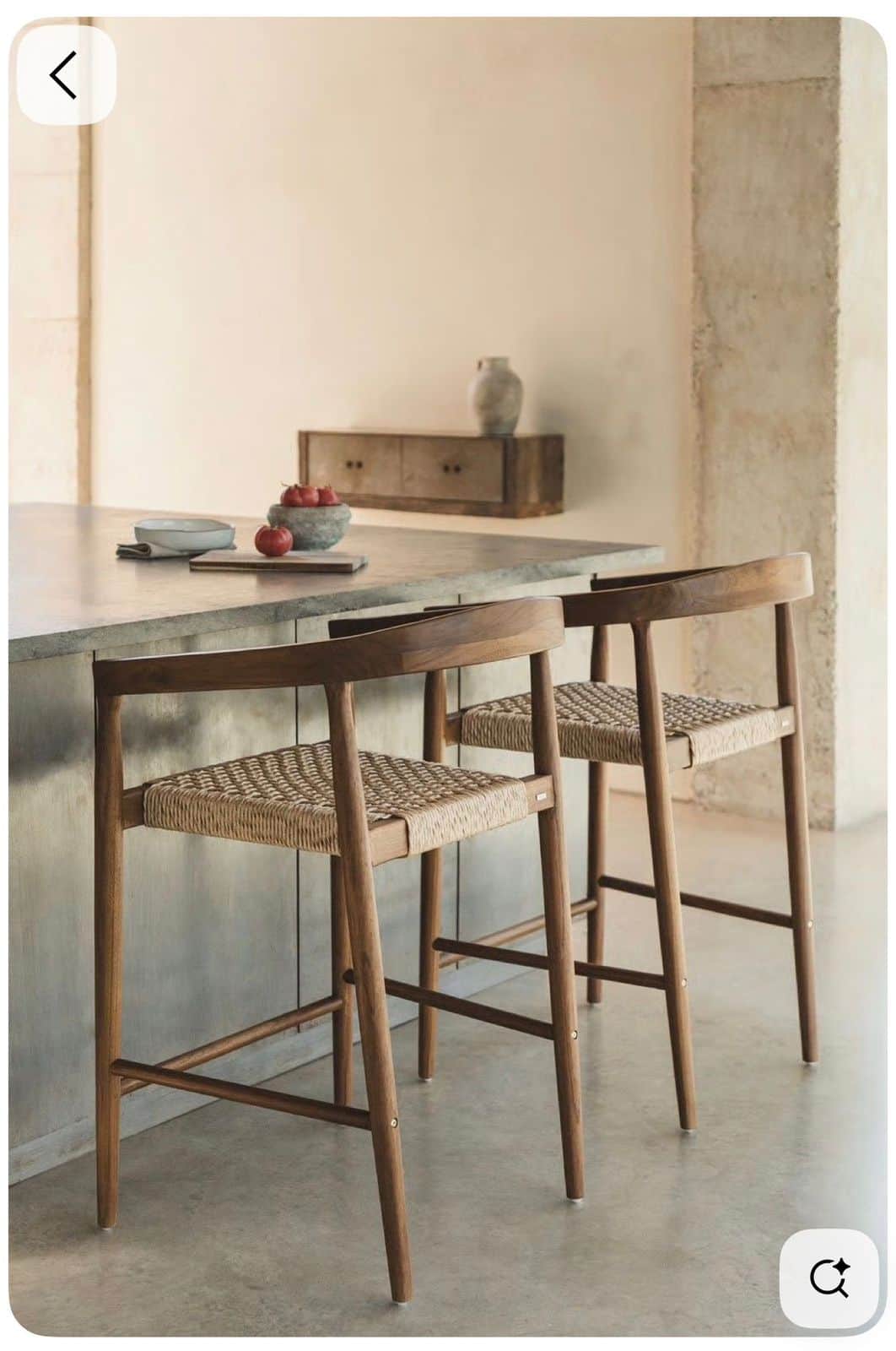A wooden bar stool featuring a curved backrest and armrests, with a tightly woven natural cord seat… — 3D model