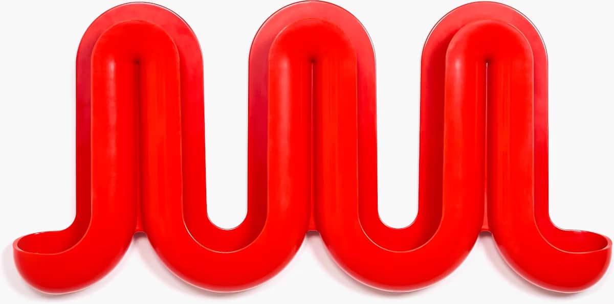 A red, wall-mounted coat rack with a unique, undulating design. The rack is composed of three interc… — free OBJ 3D model